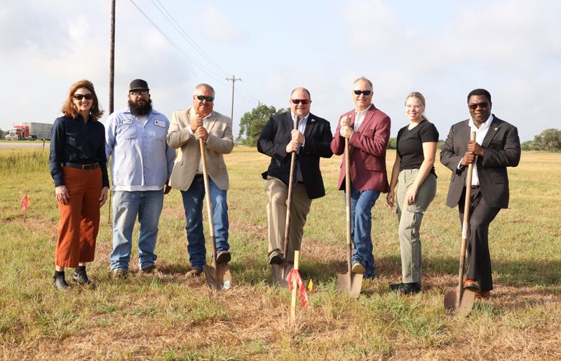 Seven people, some of them holding shovels