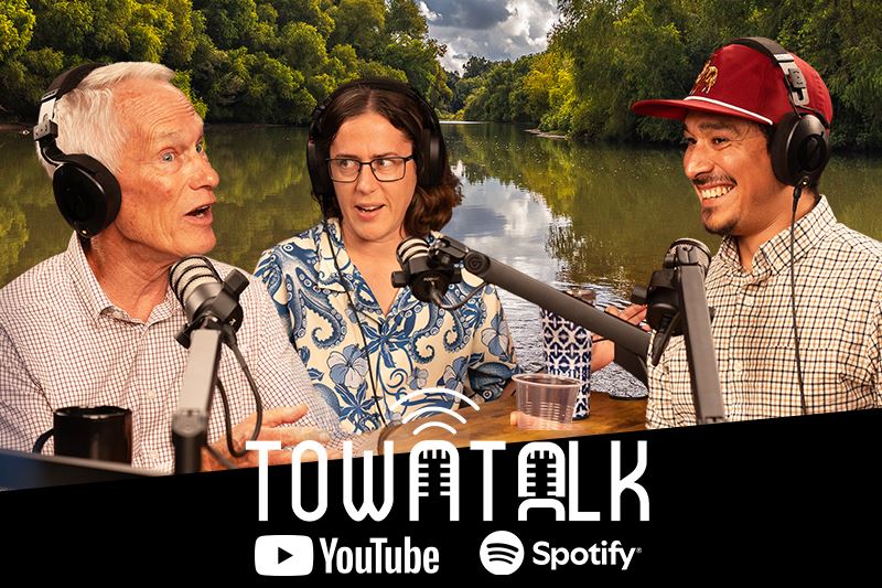 Ken, Sam and AJ with river background. Town Talk. YouTube and Spotify.