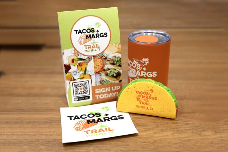 A Tacos and Margs table stand, sticker, drink holder and taco shaped stress toy