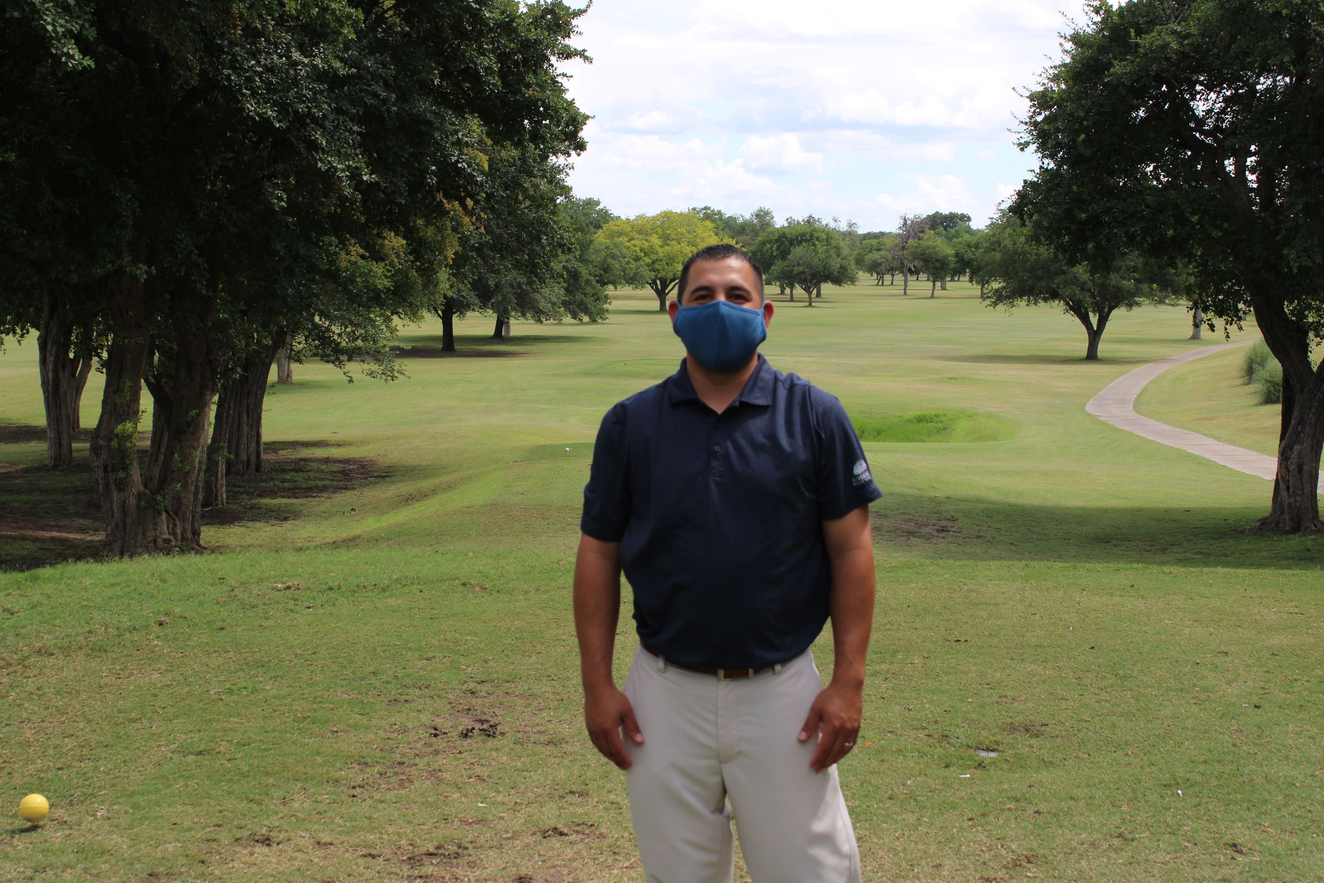 Head Golf Professional Rolando Hernandez wears a face mask at Riverside Golf Course