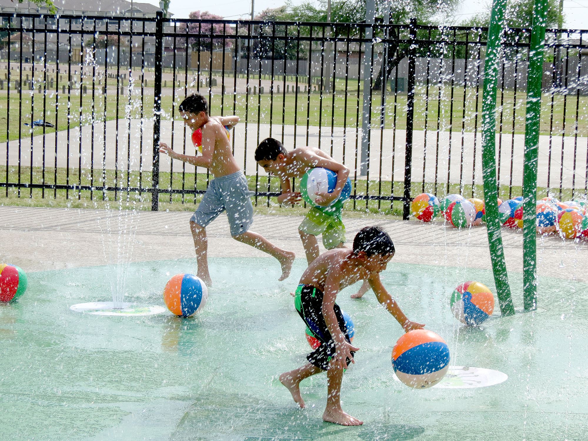 Children play at the Ethel Lee Tracy Park Splash Pad during the facility’s 2018 grand opening.