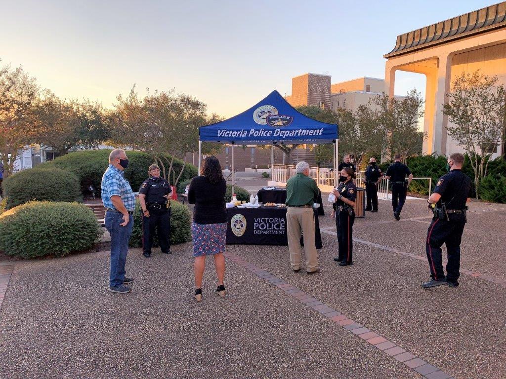 Police and residents mingle near a Victoria Police Department booth in the City Hall courtyard