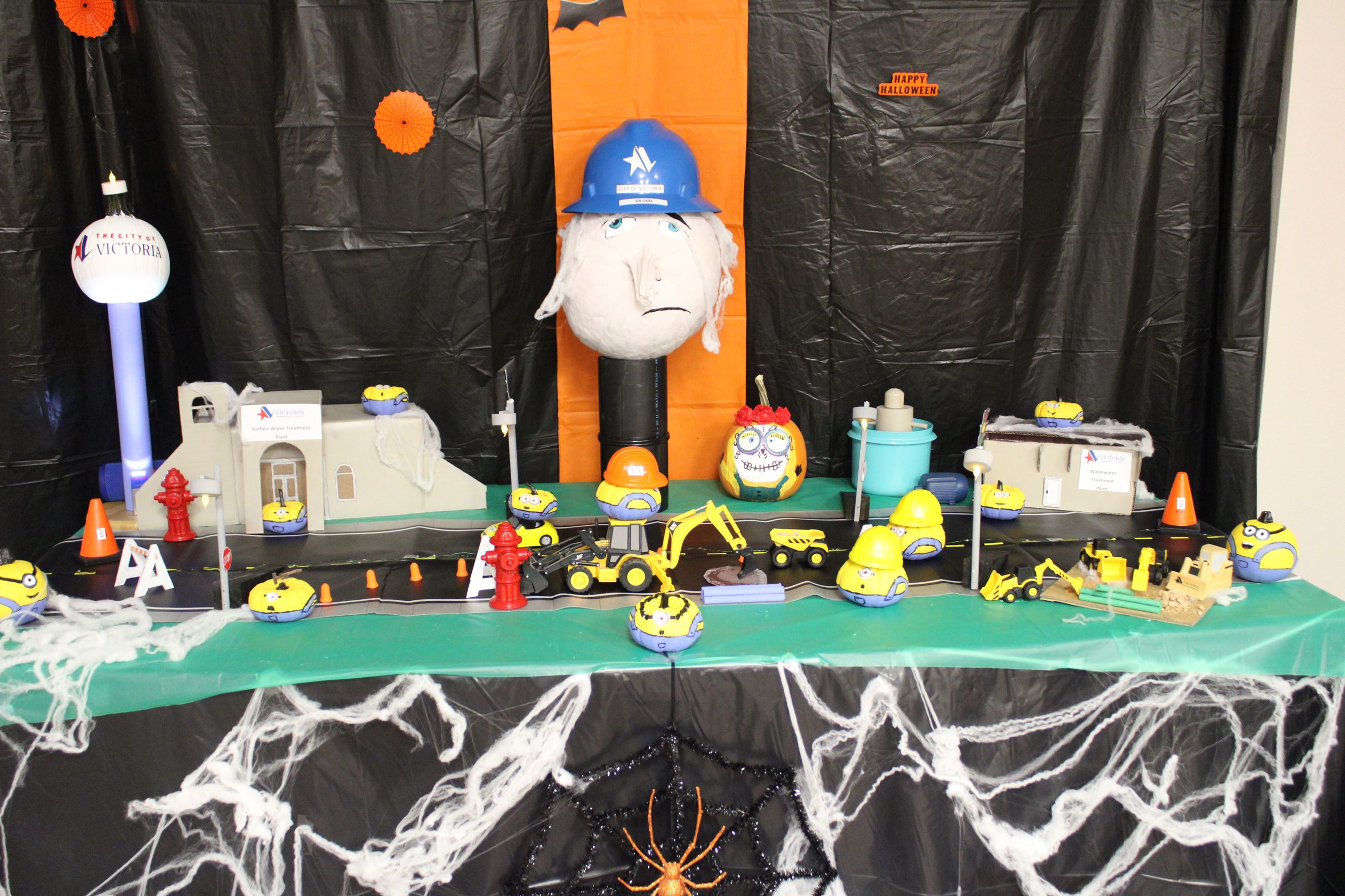 Cityscape with small pumpkins as Minions from Despicable Me. Large pumpkin is decorated as Gru.