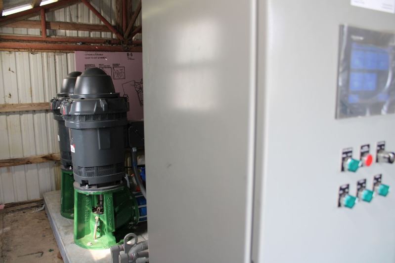 Mechanical equipment in a shed, including a large box and two motors.