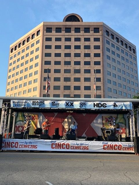 Band performs on portable stage in front of One O'Connor building downtown.