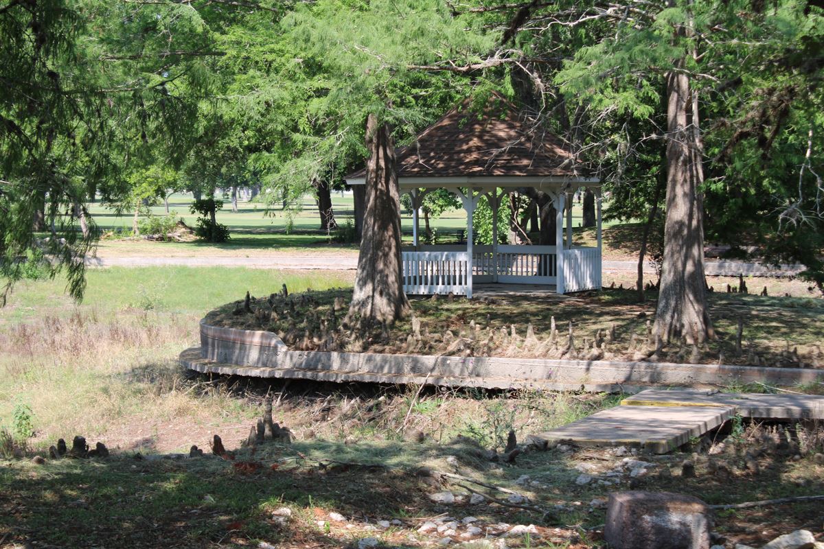 The duck pond gazebo island, with water drained and structural damage around the base
