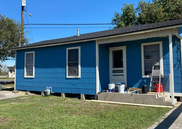 A newly painted blue house with white trim.