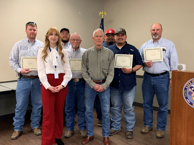 Group photo. All except two in the front hold certificates.