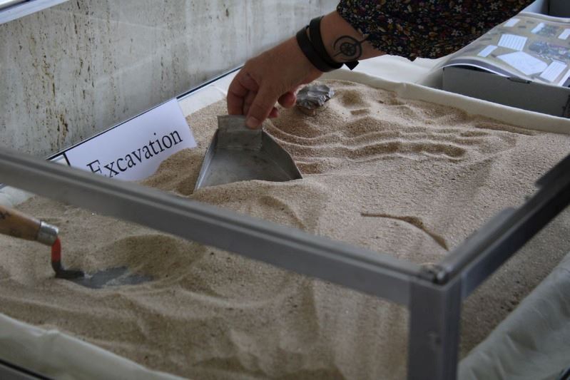 Woman places tools in glass case