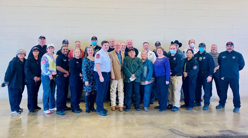 Group photo with many people, some in firefighter uniform or wearing VFD-branded jackets